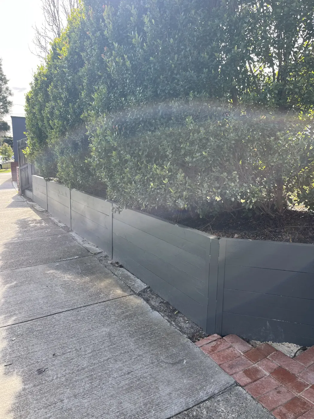 Timber retaining wall along a driveway