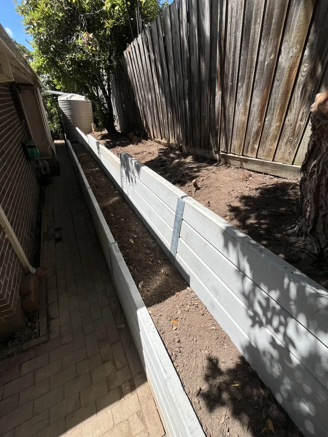 Concrete sleeper retaining wall on a sloped block